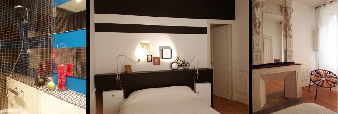 Salle de bains habillée de mosaïque sombre et niche bleue avec douche, chambre à la tête de lit noire et blanche, et dressing sous un trumeau de plâtre ancien avec chaise multicolore