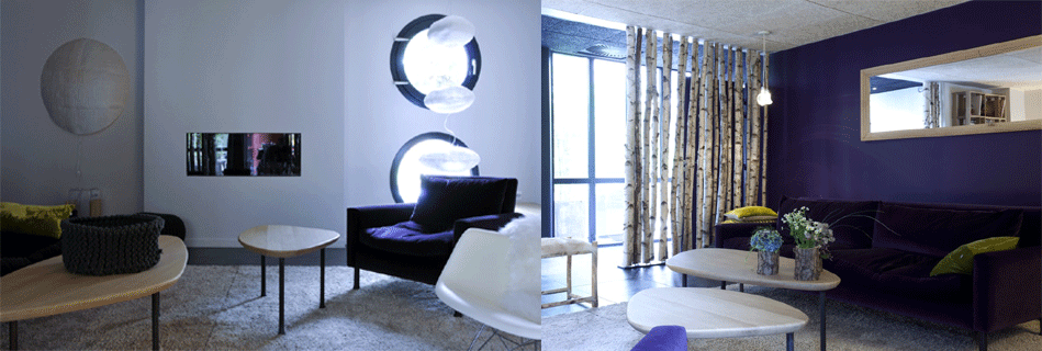 Salon de l'hôtel : appliques rondes lumineuses, fauteuil noir, rideau de rondins de bouleau et mur prune au grand miroir