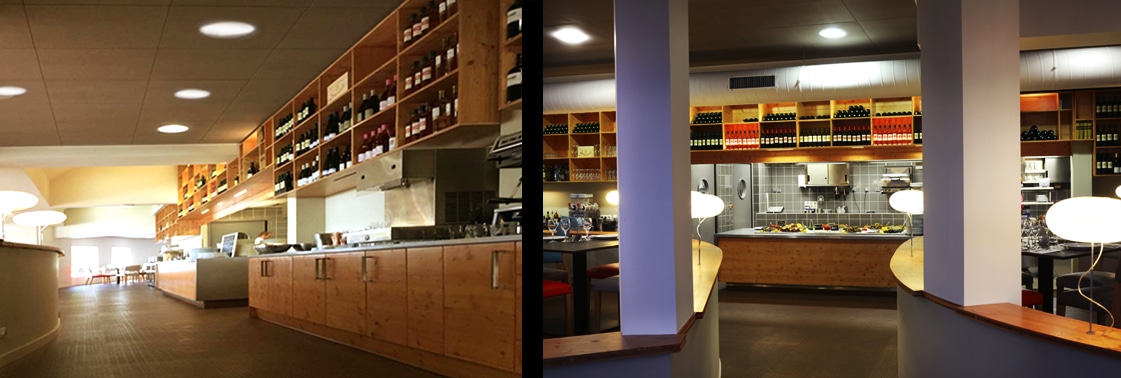 Comptoir et cuisine ouverte aux rangements bois garnis de vins, et espace bar rythmé de colonnes mauves